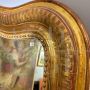 Large antique gilded mirror with a wavy shape