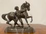 Antique antimony sculpture of a horse with a character, late 19th century