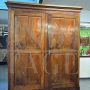 Large antique wardrobe from the early 19th century in walnut with diamond carved doors