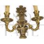 Pair of baroque style wall lights in golden brass