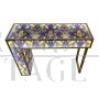 Asymmetric design console in backlit blue and gold glass