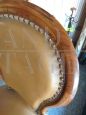 Antique armchair in walnut covered in leather