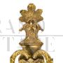 Pair of baroque style wall lights in golden brass