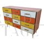 Dresser with 12 drawers in yellow and orange colored glass