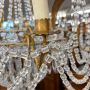 Early 1900s 8-light chandelier in gold metal with crystal drops