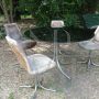 Vintage lounge set with glass and steel table and 4 pony skin chairs, 1970s