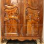 Antique Louis XV wardrobe or cupboard in walnut and cherry with carvings, 18th century