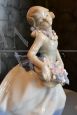 Vintage porcelain sculpture, little girl with a basket of flowers