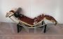 Bauhaus-inspired golden chaise longue in cowhide