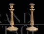 Pair of antique candlesticks from the French Empire period in gilded bronze