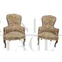 Pair of vintage wooden armchairs covered with floral fabric