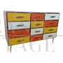 Dresser with 12 drawers in yellow and orange colored glass