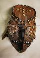 Antique African tribal mask with beads and leopard skin