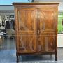 Large antique wardrobe from the early 19th century in walnut with diamond carved doors                            