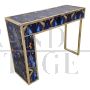 Asymmetric design console in backlit blue and gold glass