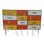 Dresser with 12 drawers in yellow and orange colored glass