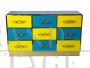 Design chest of drawers with 9 drawers in yellow and blue glass