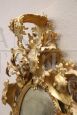 Antique baroque oval cartouche mirror in carved and gilded wood, 18th century