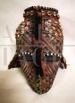 Antique African tribal mask with beads and leopard skin