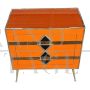 Art deco style bedside cabinet in orange glass with geometries