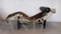 Bauhaus-inspired golden chaise longue in cowhide