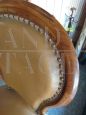 Antique armchair in walnut covered in leather