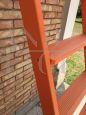 Vintage ladder in orange lacquered wood with a height of 3 meters