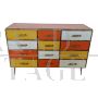 Dresser with 12 drawers in yellow and orange colored glass