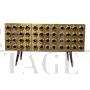 Three-door brass sideboard with circular red glass inserts