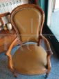 Antique armchair in walnut covered in leather