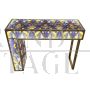 Asymmetric design console in backlit blue and gold glass