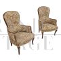 Pair of vintage wooden armchairs covered with floral fabric