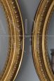 Pair of antique carved and gilded oval frames