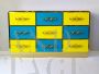 Design chest of drawers with 9 drawers in yellow and blue glass