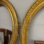 Pair of antique carved and gilded oval frames