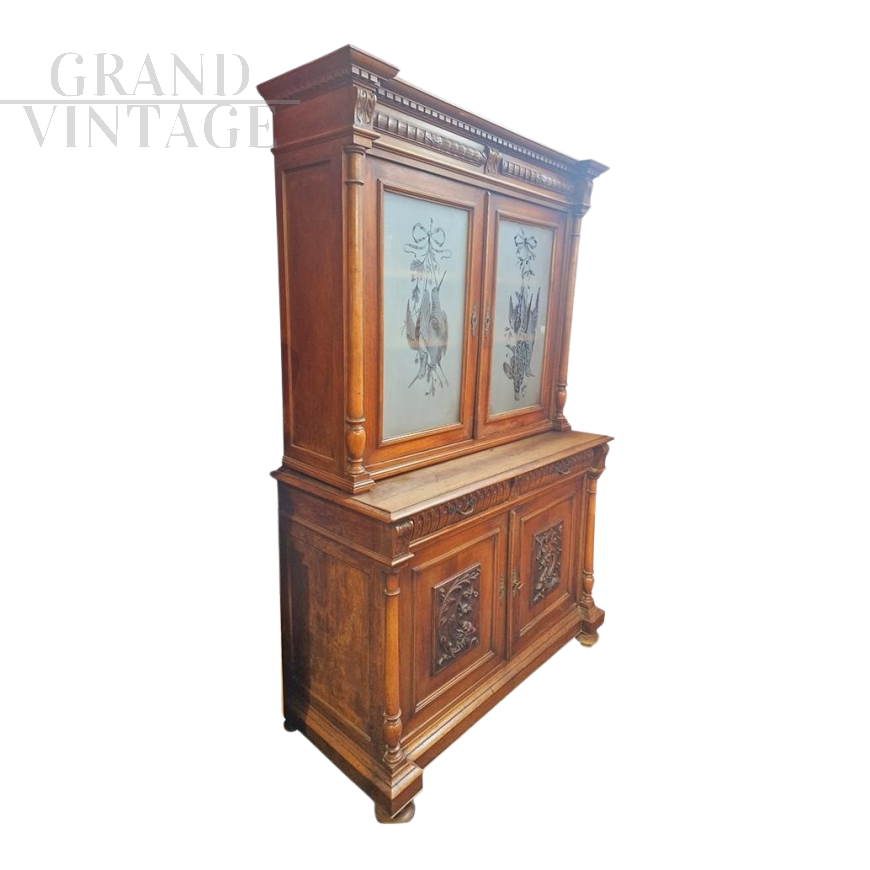 Antique cupboard in carved walnut with glass doors, 19th century France