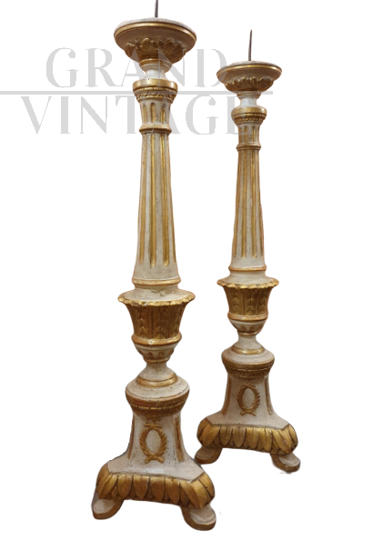 Pair of lacquered and gilded wooden candlesticks