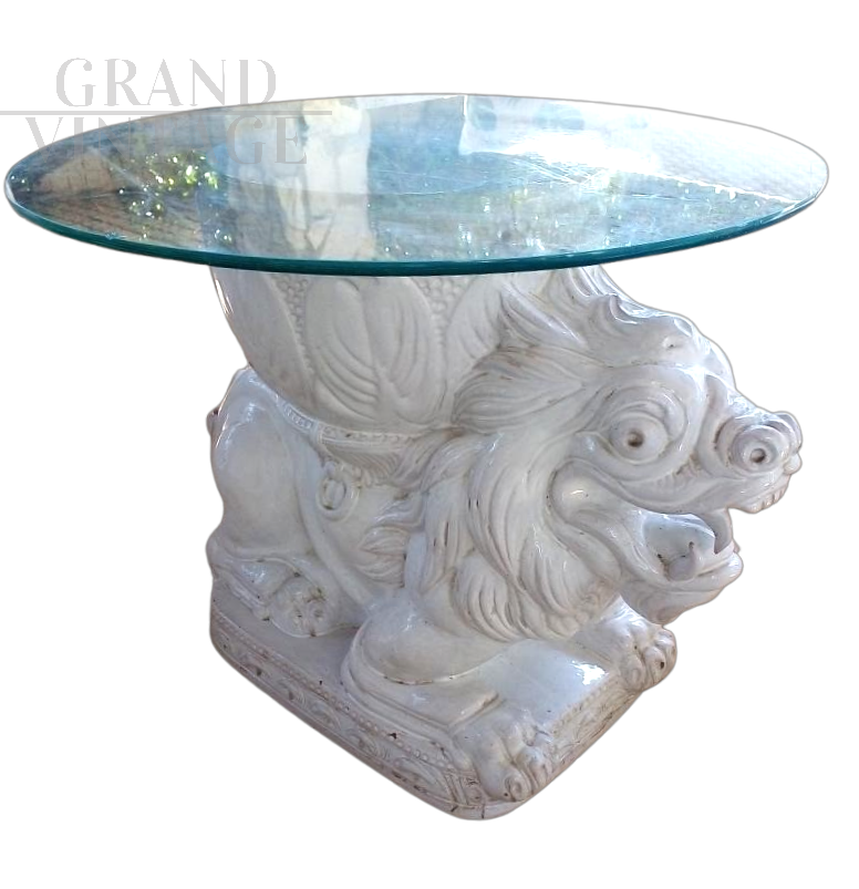 Vintage ethnic style coffee table with white ceramic lion base and glass top